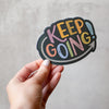 Don't stop, keep going! Colorful hand lettered sticker by Em Dash Paper Co, printed on weather-resistant vinyl and great for your laptop, water bottle, or bathroom mirror.